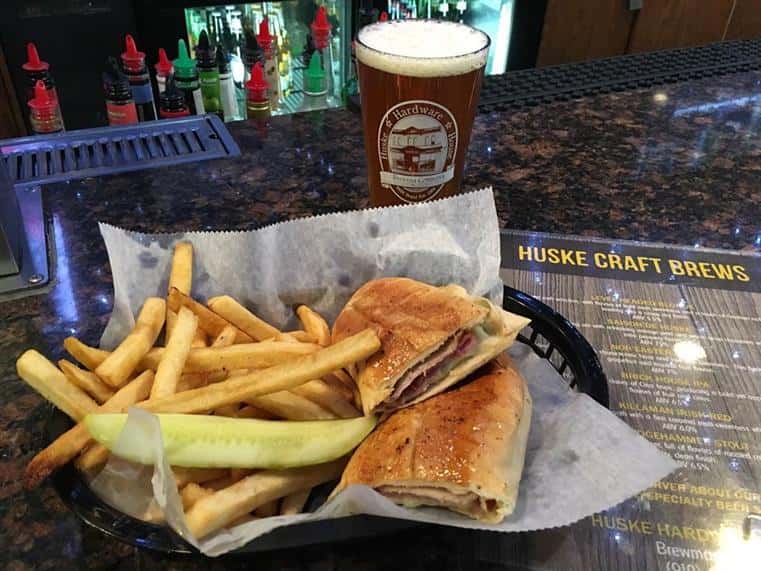 Huske's Famous Cuban: Huske’s version of a favorite. Roasted pork, ham, Dijon mustard, sliced pickles and Swiss cheese on Cuban bread brushed with a toasted honey glaze